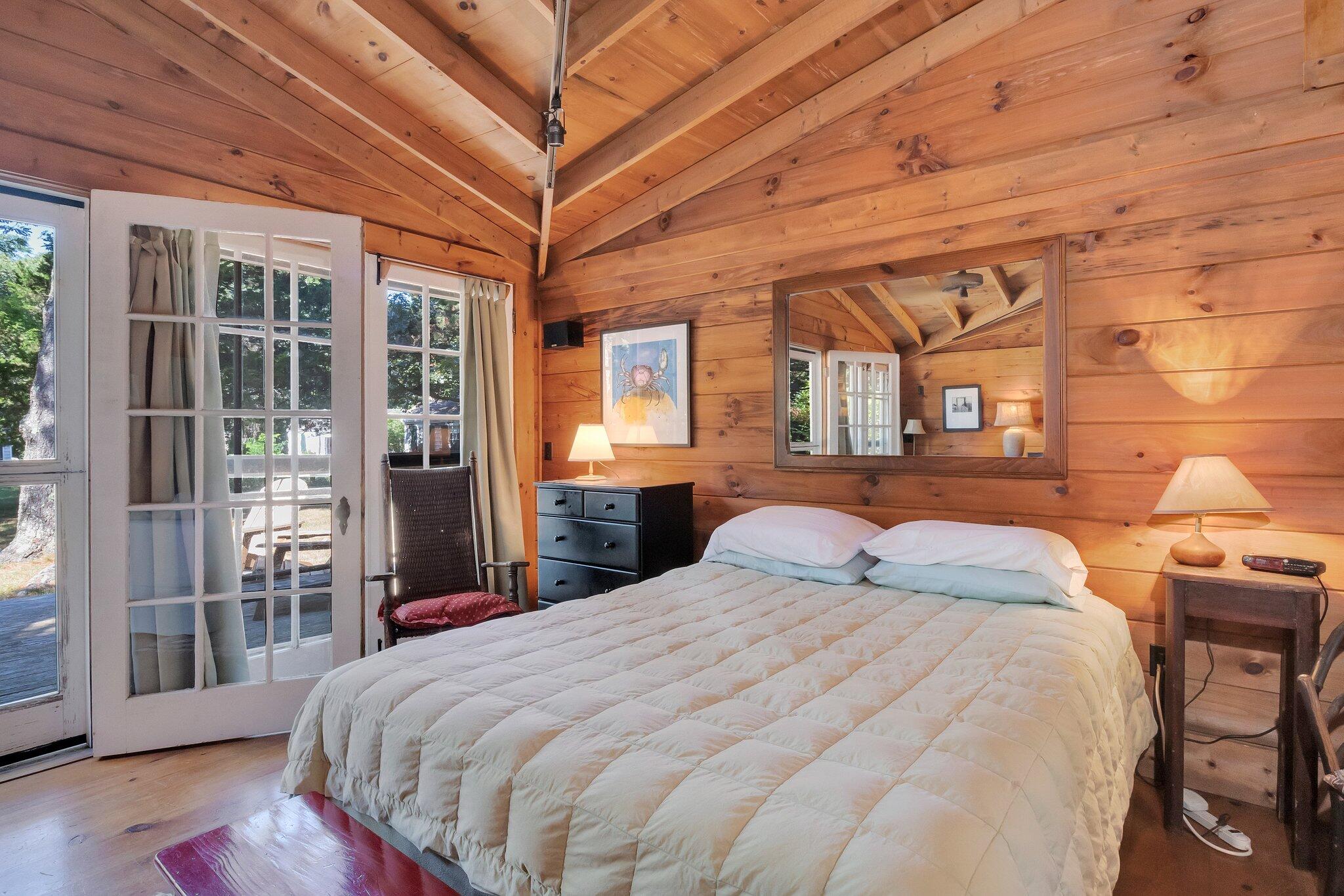 1975 State Highway, Unit 9 Eastham, MA 02642 - Photo 9 of 23 a bedroom with a large bed and a large window