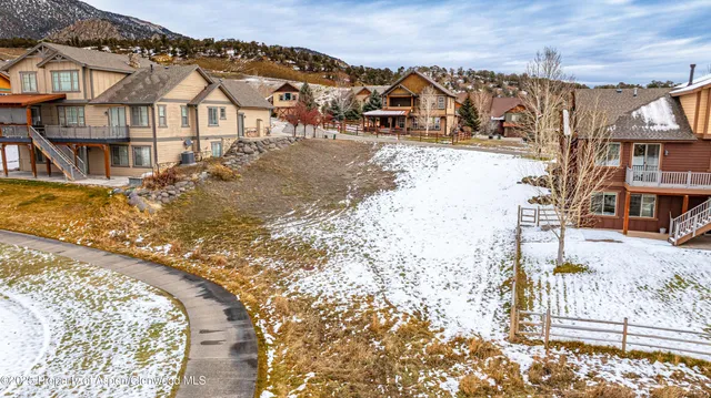a view of a house with a snow on the road