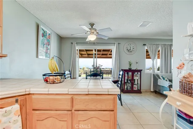 a very nice looking kitchen with a large window appliances and cabinets