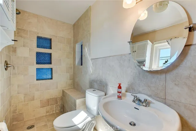 a bathroom with a sink mirror and toilet