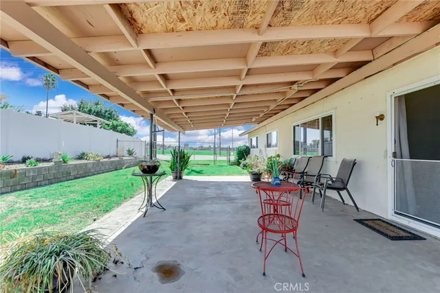 a view of a house with backyard sitting area and garden