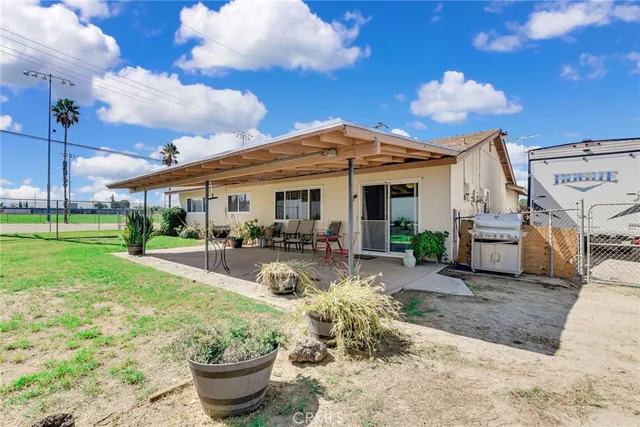 a view of a house with backyard porch and sitting area