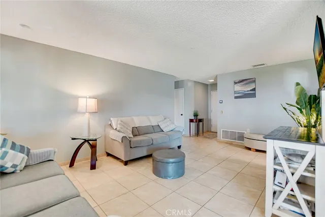a living room with furniture a couch and potted plant
