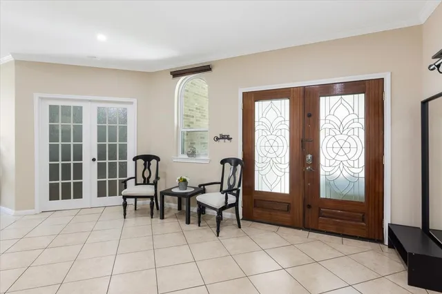 a living room with furniture a window and gym equipment
