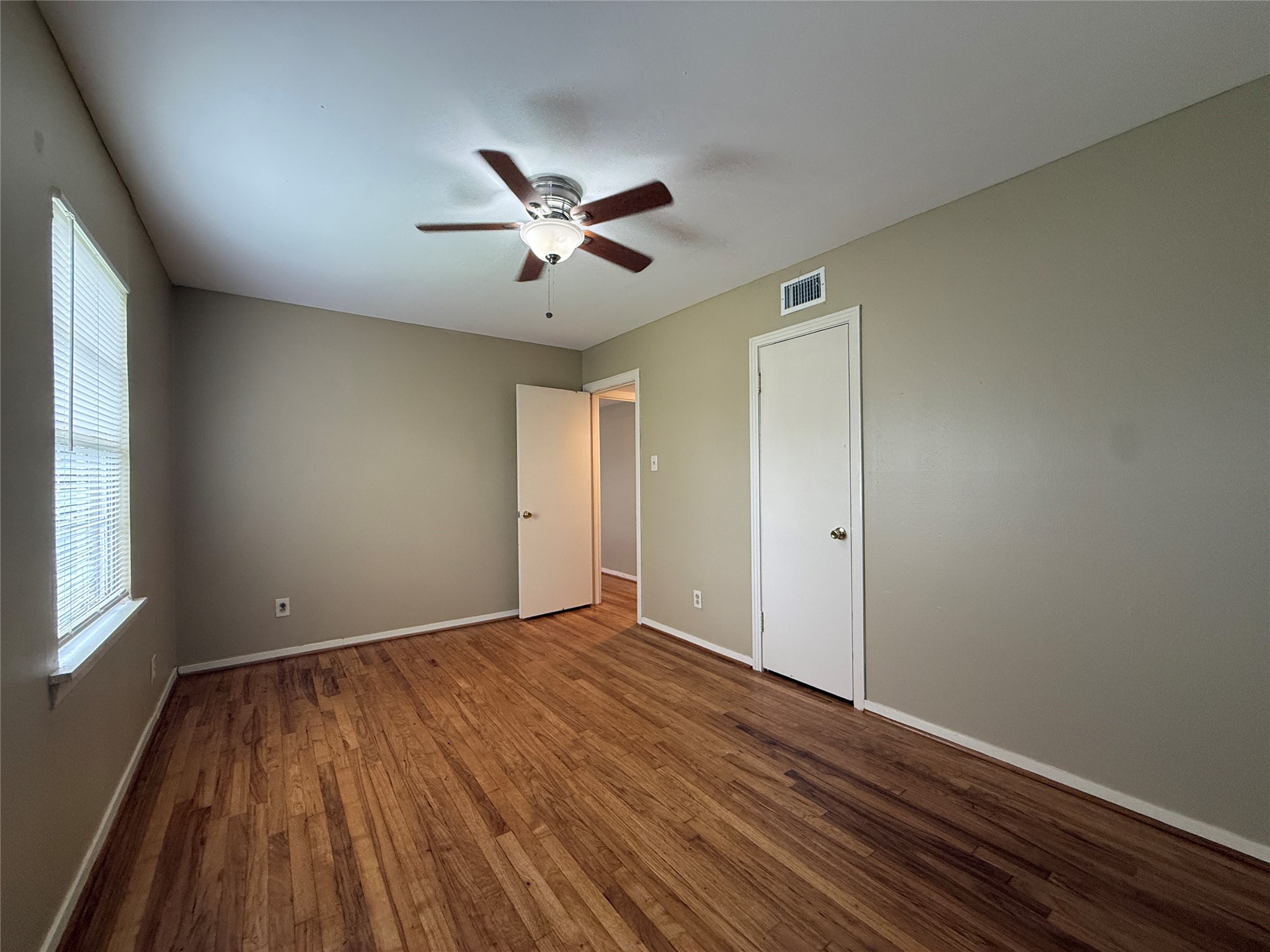 1318 Heights Boulevard, Unit 4 Houston, TX 77008 - Photo 14 of 21 an empty room with wooden floor and windows