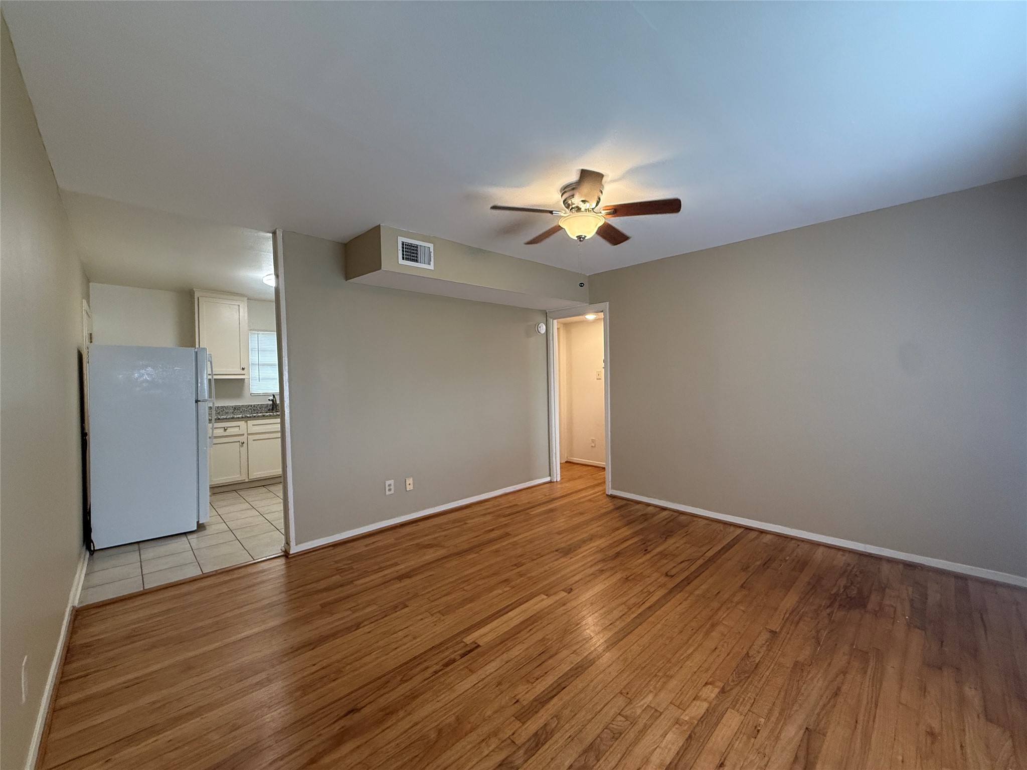 1318 Heights Boulevard, Unit 4 Houston, TX 77008 - Photo 18 of 21 a view of an empty room with a window and wooden floor
