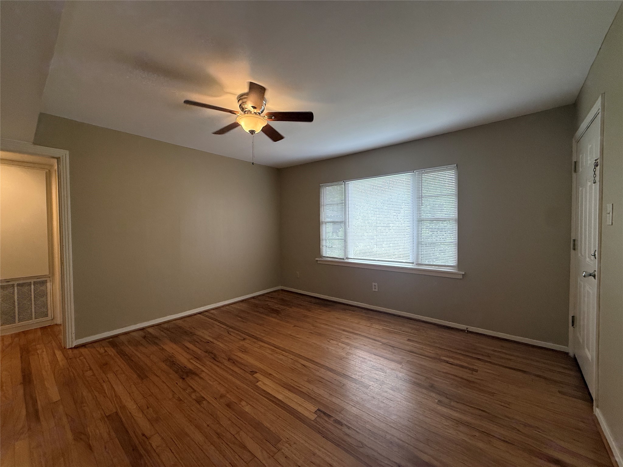 1318 Heights Boulevard, Unit 4 Houston, TX 77008 - Photo 6 of 21 wooden floor in an empty room with a window