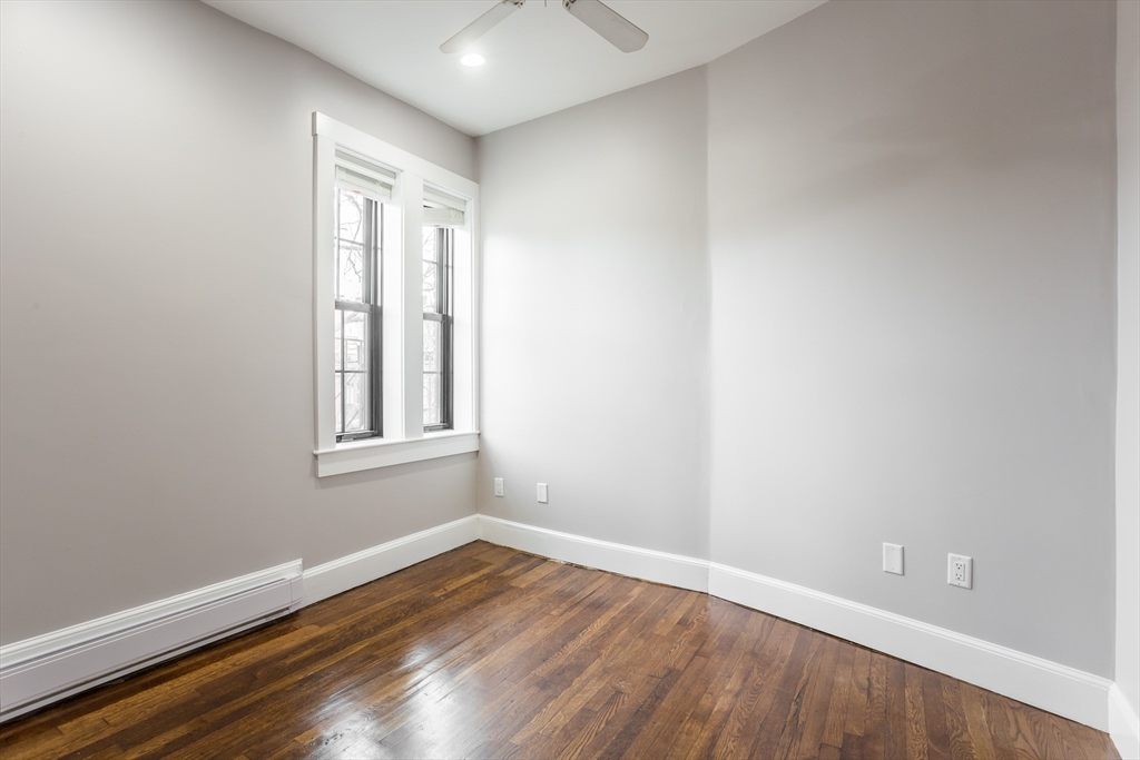 534 Tremont Street, Unit 4 Boston, MA 02118 - Photo 11 of 16 a view of an empty room with wooden floor and a window