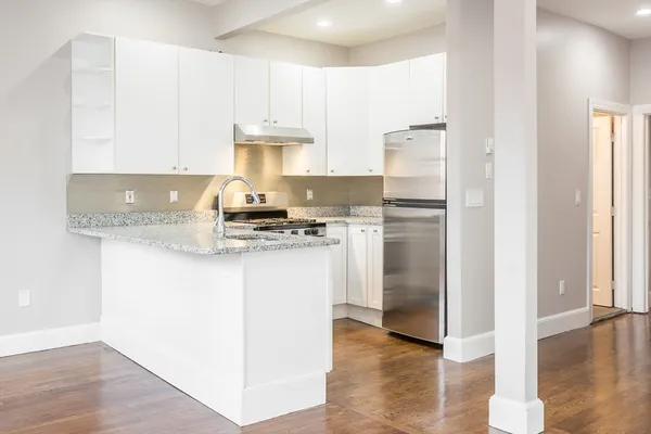 a kitchen with a refrigerator a stove a microwave and cabinets