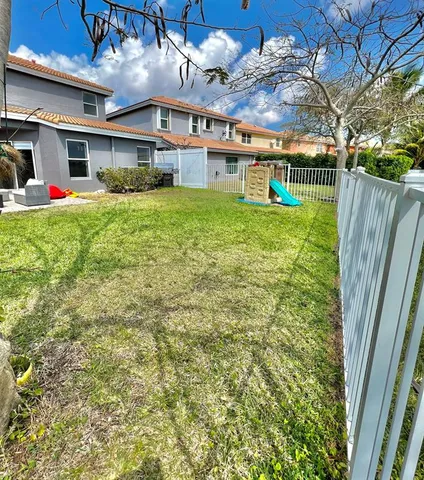 a view of a yard with table and chairs and a yard