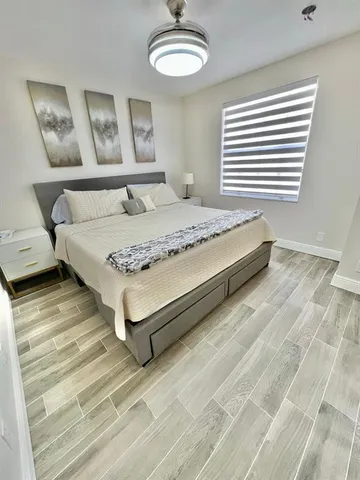 a bedroom with a bed and a chandelier