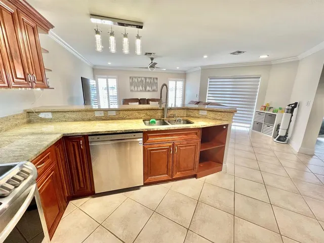 a kitchen with stainless steel appliances granite countertop a sink and cabinets