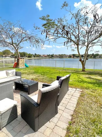 a view of a swimming pool with a patio and a garden