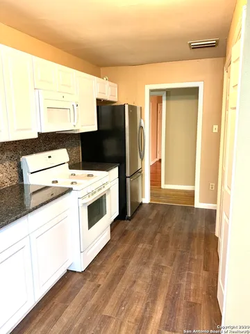 a kitchen with a stove and a refrigerator