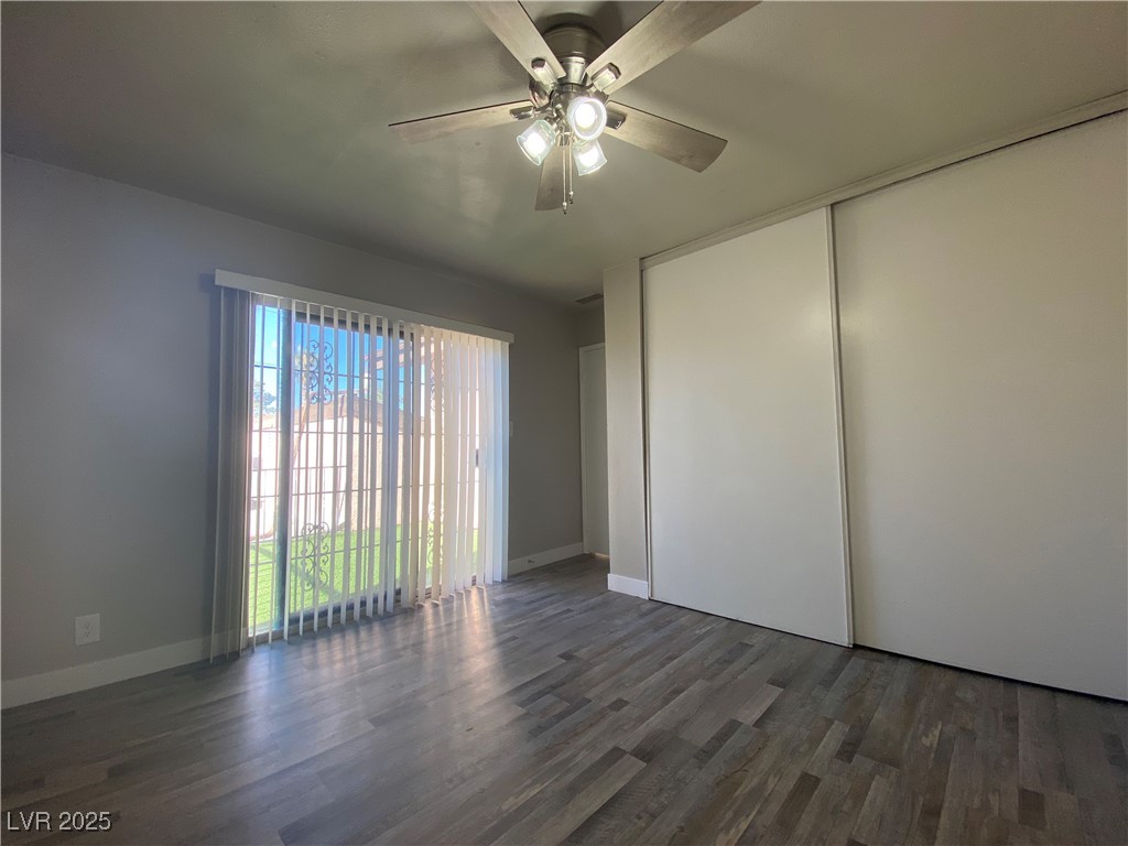 1722 East University Avenue, Unit 8 Las Vegas, NV 89119 - Photo 11 of 28 Spare room featuring dark wood-type flooring and a ceiling fan