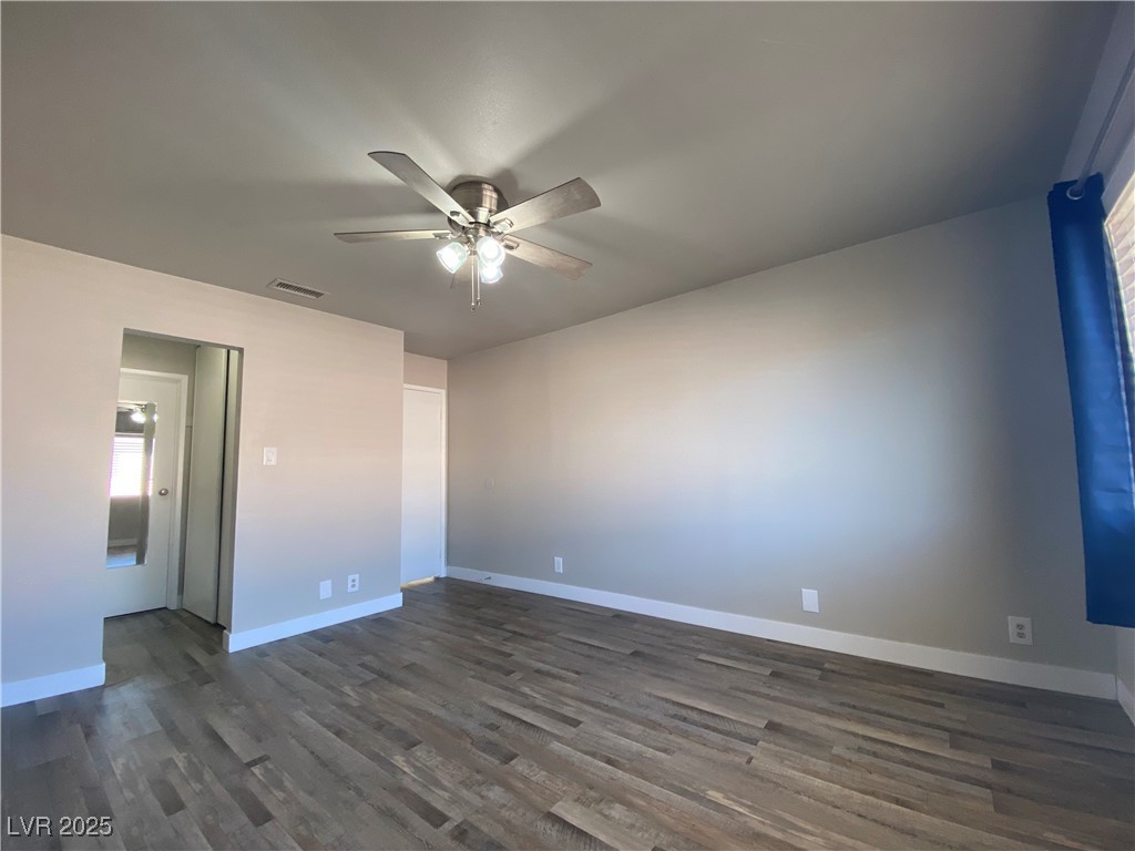 1722 East University Avenue, Unit 8 Las Vegas, NV 89119 - Photo 16 of 28 Spare room with dark wood finished floors and ceiling fan