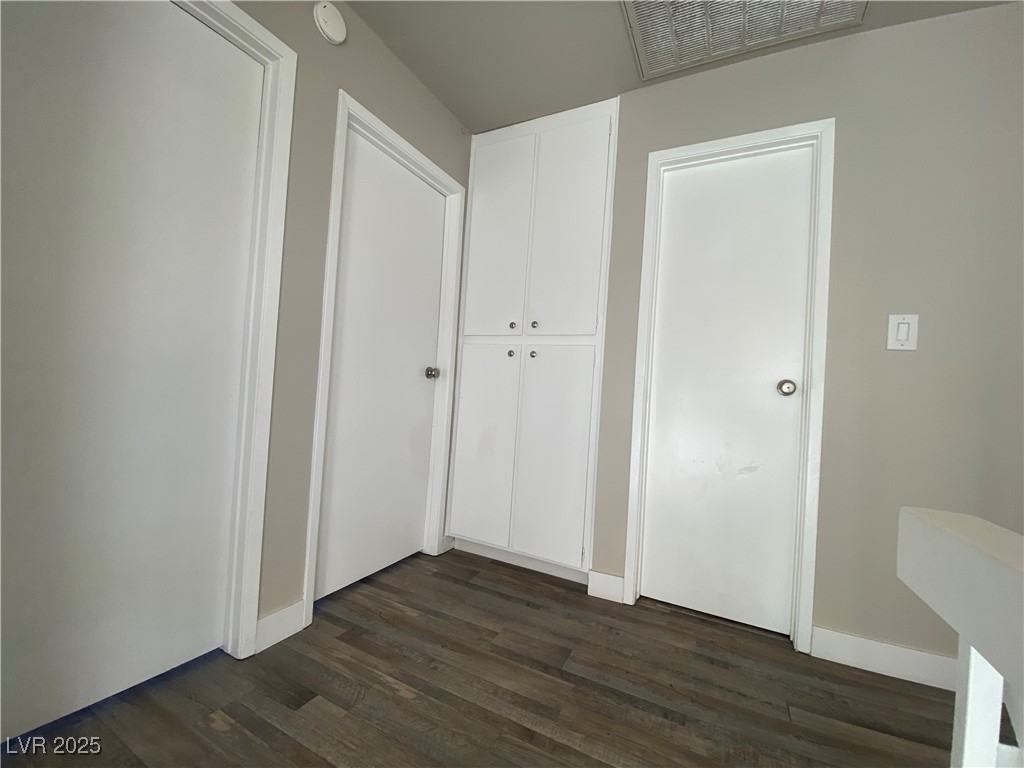 1722 East University Avenue, Unit 8 Las Vegas, NV 89119 - Photo 17 of 28 Unfurnished bedroom featuring dark wood-type flooring and baseboards