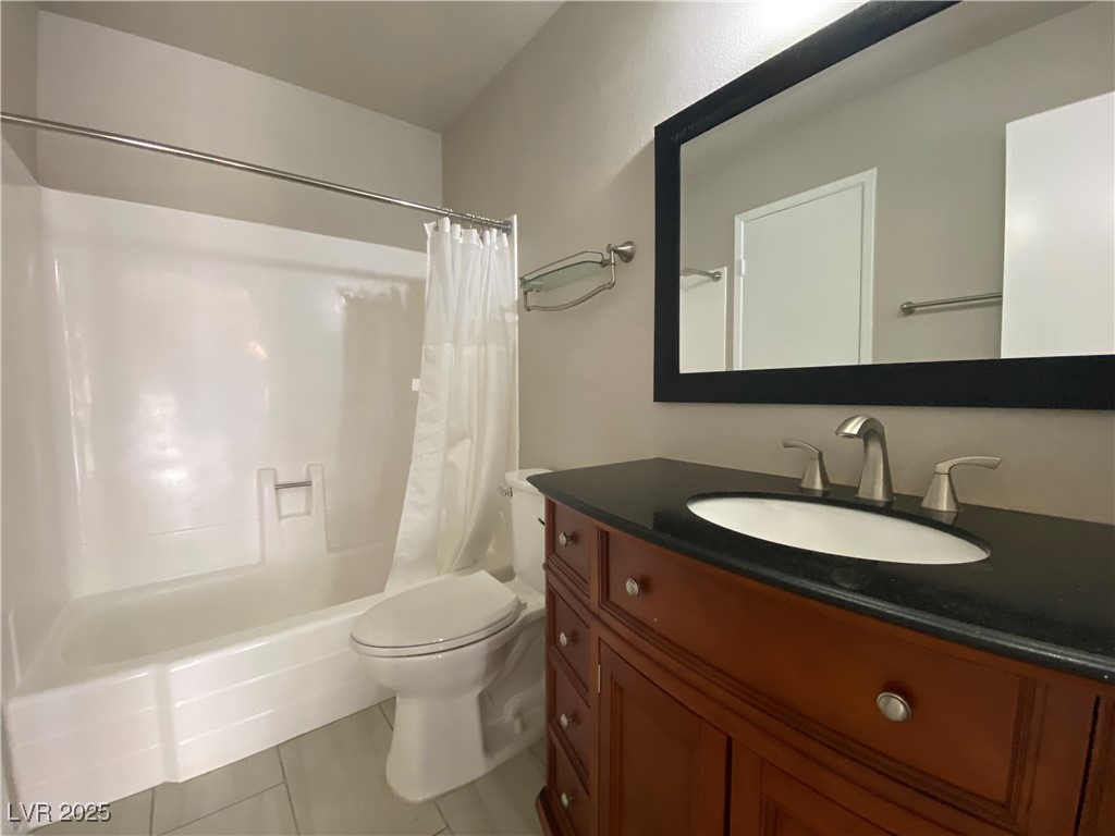 1722 East University Avenue, Unit 8 Las Vegas, NV 89119 - Photo 18 of 28 Bathroom with light tile patterned floors, shower / tub combo, and vanity
