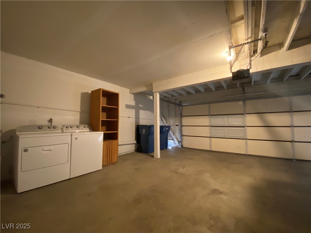 1722 East University Avenue, Unit 8 Las Vegas, NV 89119 - Photo 22 of 28 Garage with washing machine and dryer and a garage door opener
