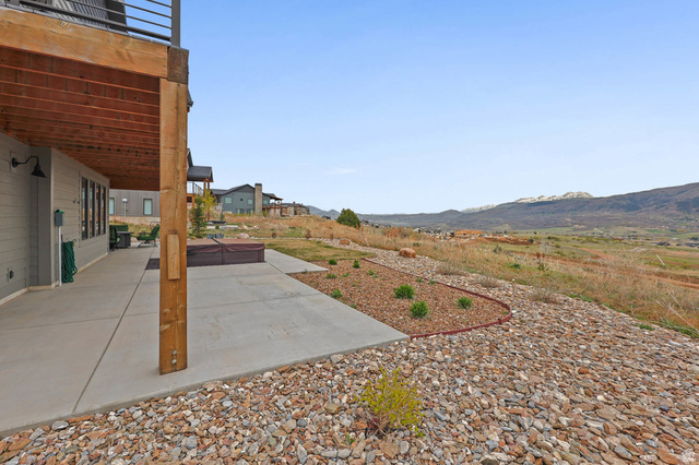 4527 North Seven Bridges Road Eden, UT 84310 - Photo 55 of 65 View of yard with a patio, a hot tub, and a mountain view