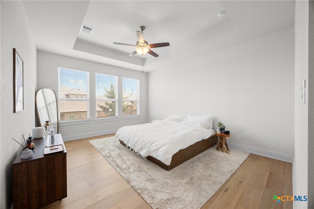 109 High Plains Drive Georgetown, TX 78628 - Photo 14 of 43 a spacious bedroom with a bed and a large window