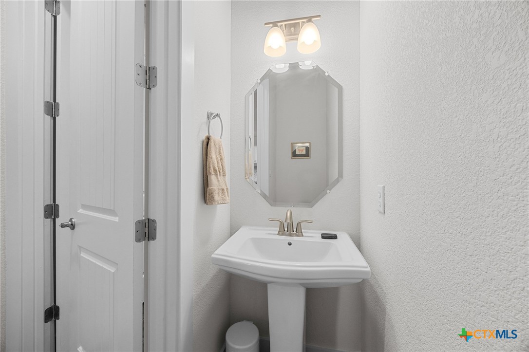 109 High Plains Drive Georgetown, TX 78628 - Photo 22 of 43 a bathroom with a sink a mirror and shower