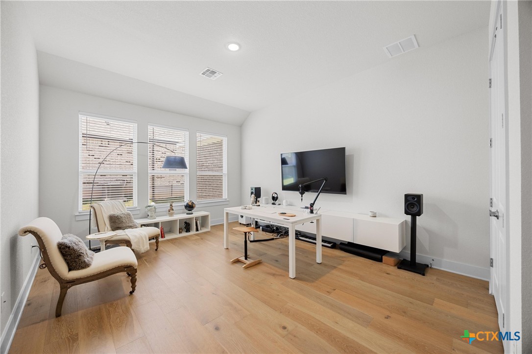 109 High Plains Drive Georgetown, TX 78628 - Photo 24 of 43 a living room with furniture and a flat screen tv