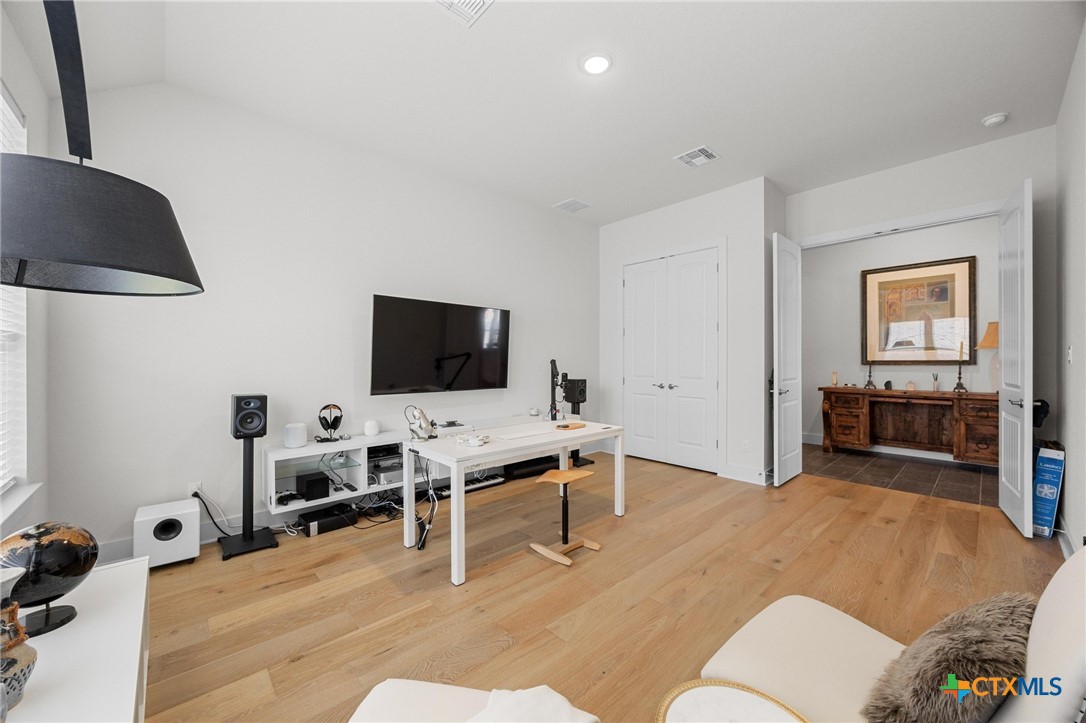 109 High Plains Drive Georgetown, TX 78628 - Photo 25 of 43 a living room with furniture and a flat screen tv