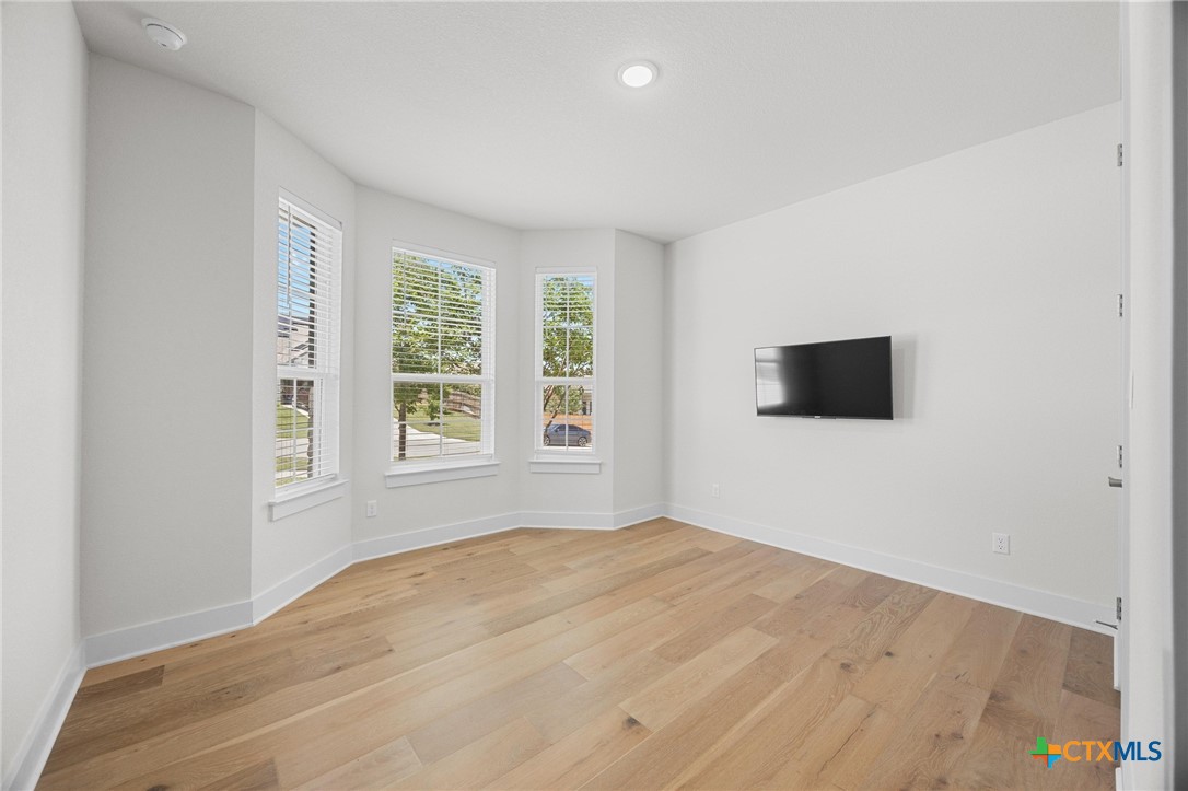109 High Plains Drive Georgetown, TX 78628 - Photo 27 of 43 a view of empty room with wooden floor and fan