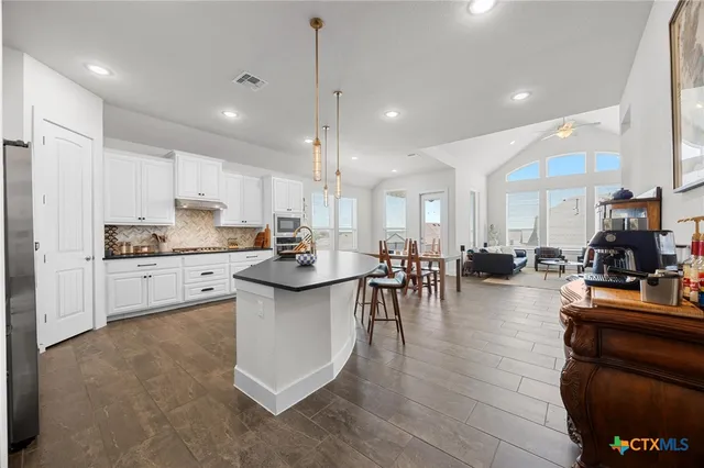 a living room with furniture flat screen tv and a large window