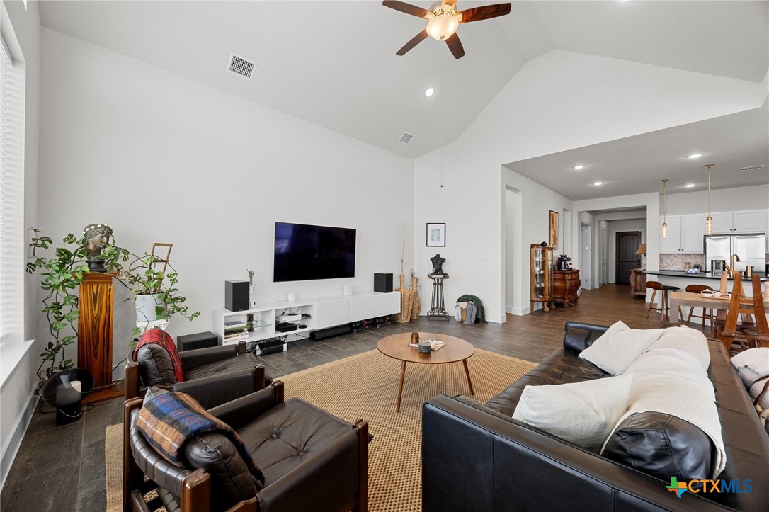 109 High Plains Drive Georgetown, TX 78628 - Photo 6 of 43 a living room with furniture and a flat screen tv