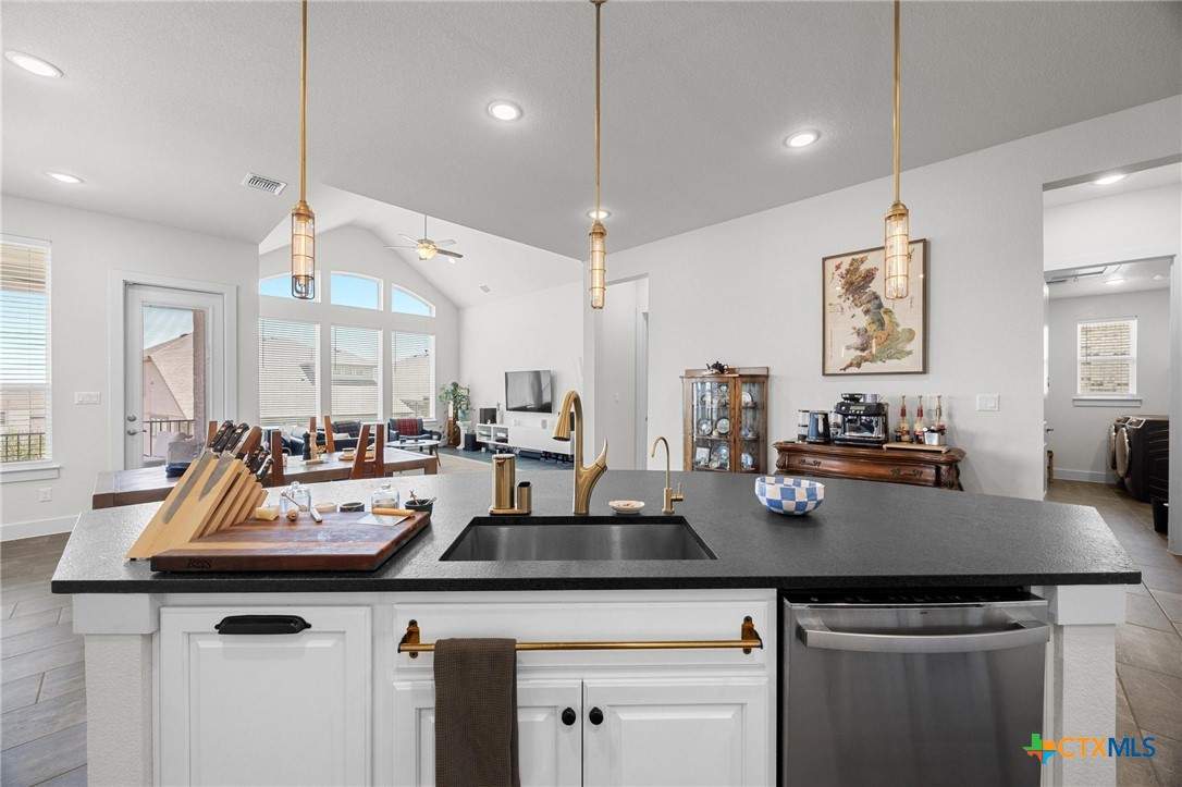 109 High Plains Drive Georgetown, TX 78628 - Photo 10 of 43 a view of kitchen island a sink a counter space and living room view