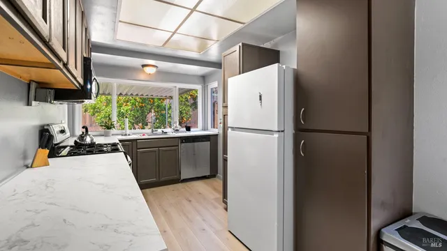 a kitchen with a refrigerator and a sink