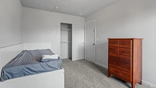 a living room with furniture and a dresser