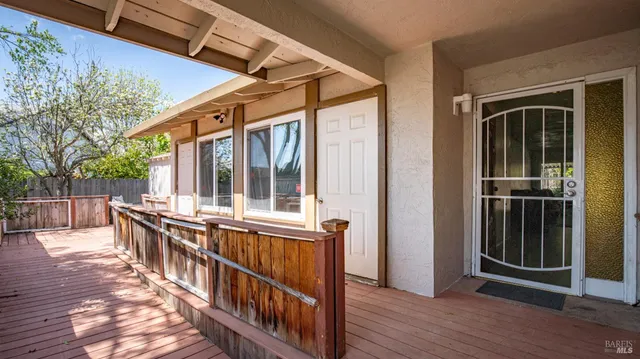 a view of a house and wooden deck