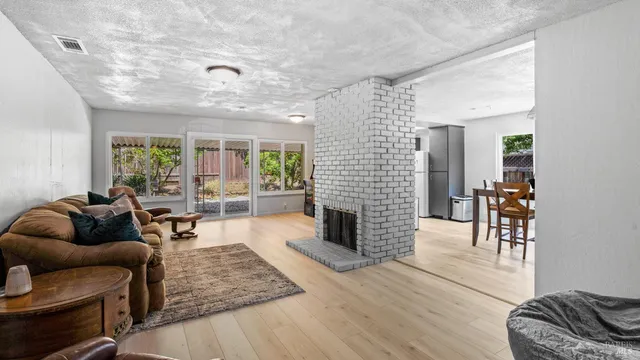 a living room with furniture and a fireplace