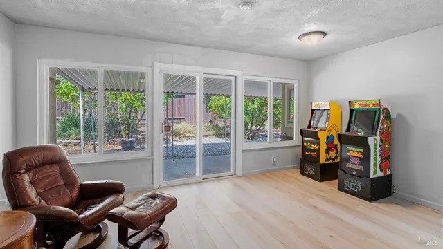 a living room with furniture and a floor to ceiling window
