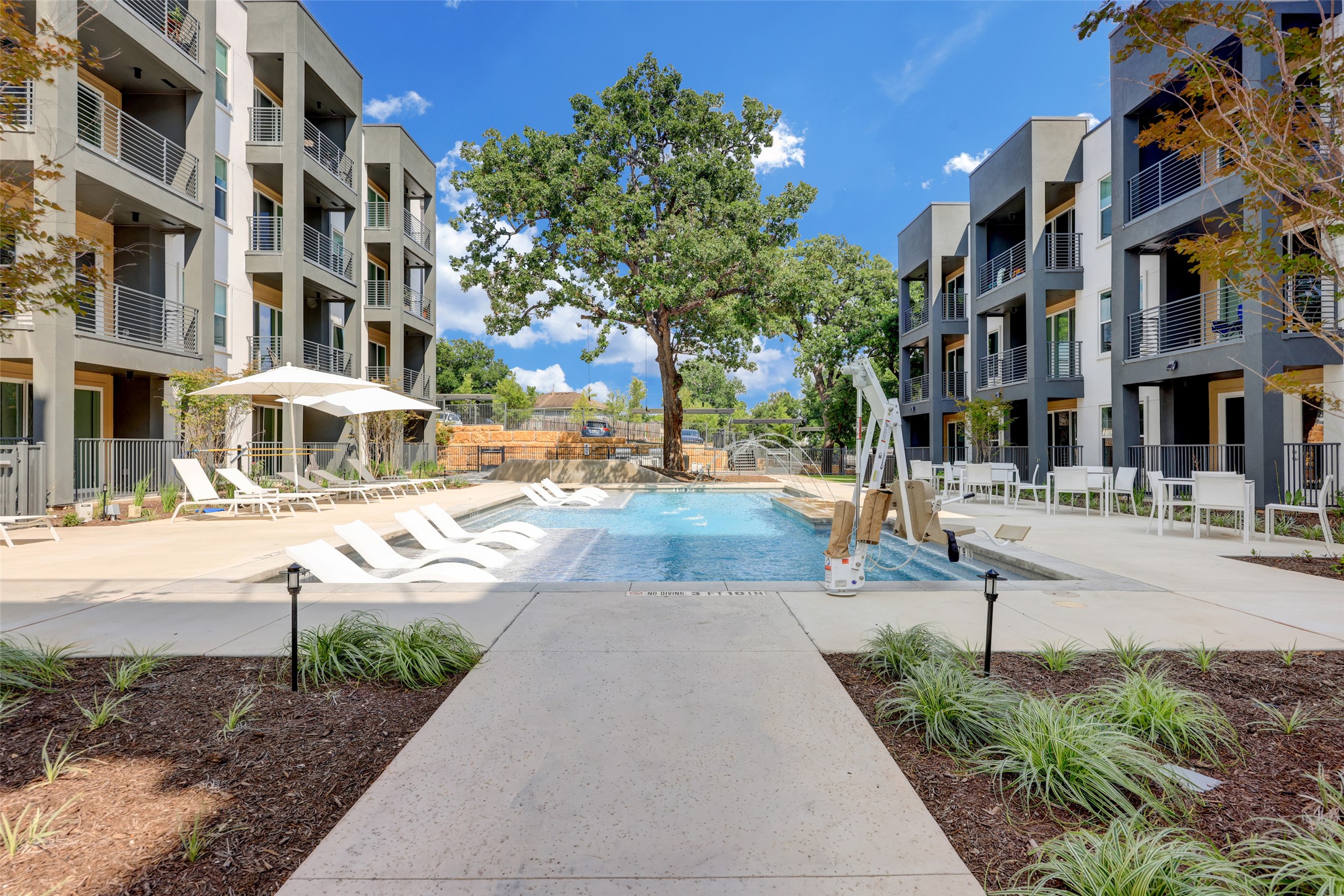 The community pool which features sun loungers, plenty of seating and bbq grills