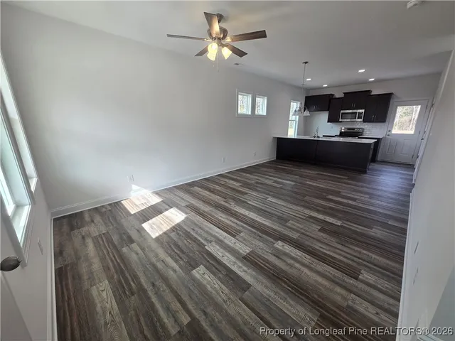 a view of kitchen and hall with wooden floor