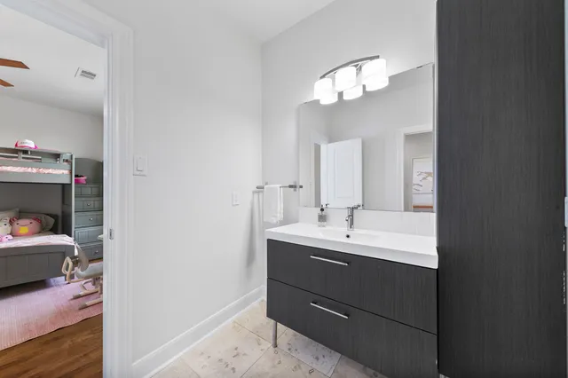 a bathroom with a sink vanity and a mirror