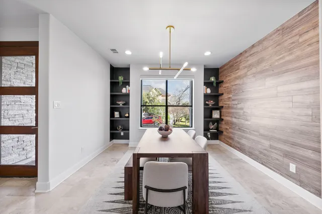 a dining room with furniture and window