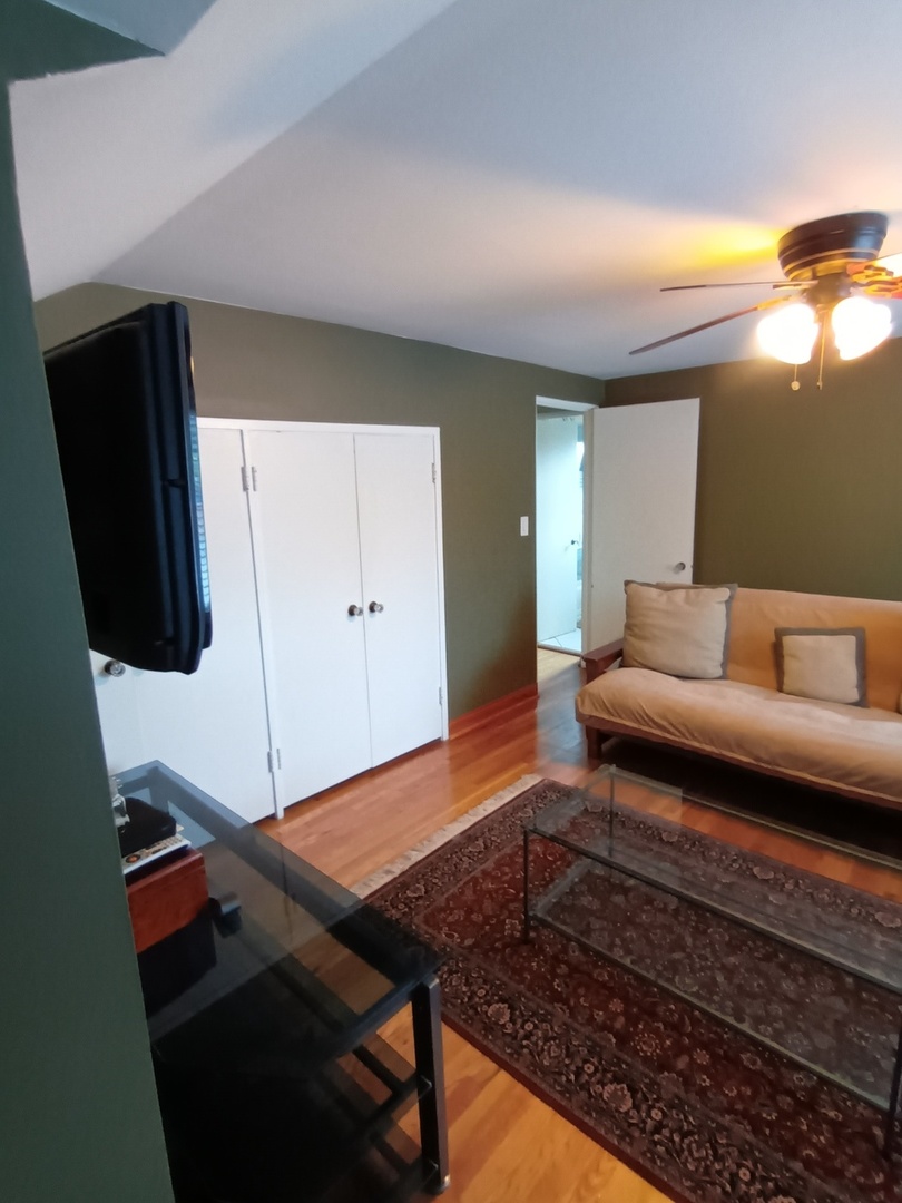 8742 East Prairie Road Skokie, IL 60076 - Photo 15 of 29 a living room with furniture and a flat screen tv