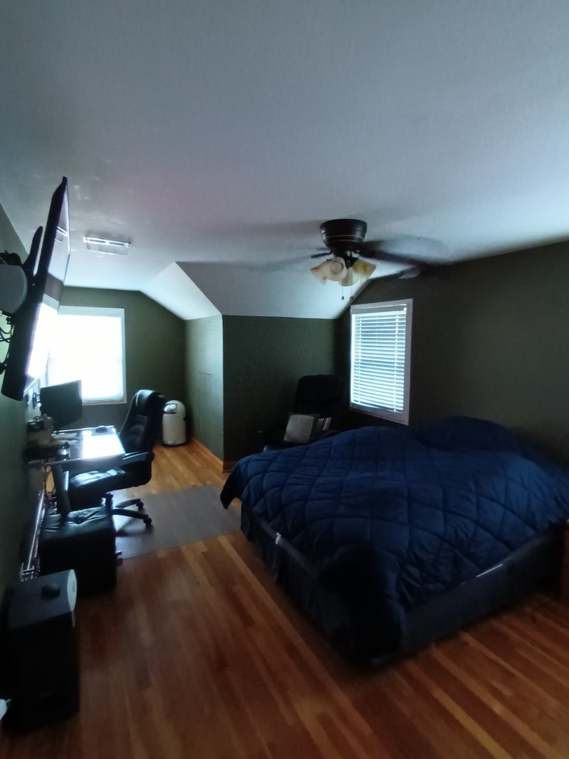 8742 East Prairie Road Skokie, IL 60076 - Photo 18 of 29 a bed room with a bed window and a chandelier