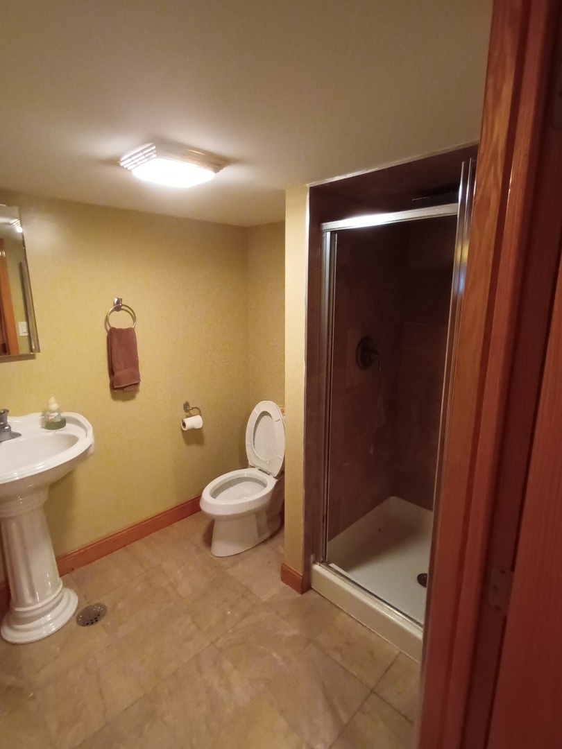 8742 East Prairie Road Skokie, IL 60076 - Photo 24 of 29 a bathroom with a toilet and a shower