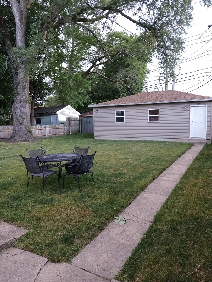 8742 East Prairie Road Skokie, IL 60076 - Photo 27 of 29 a backyard of a house with table and chairs