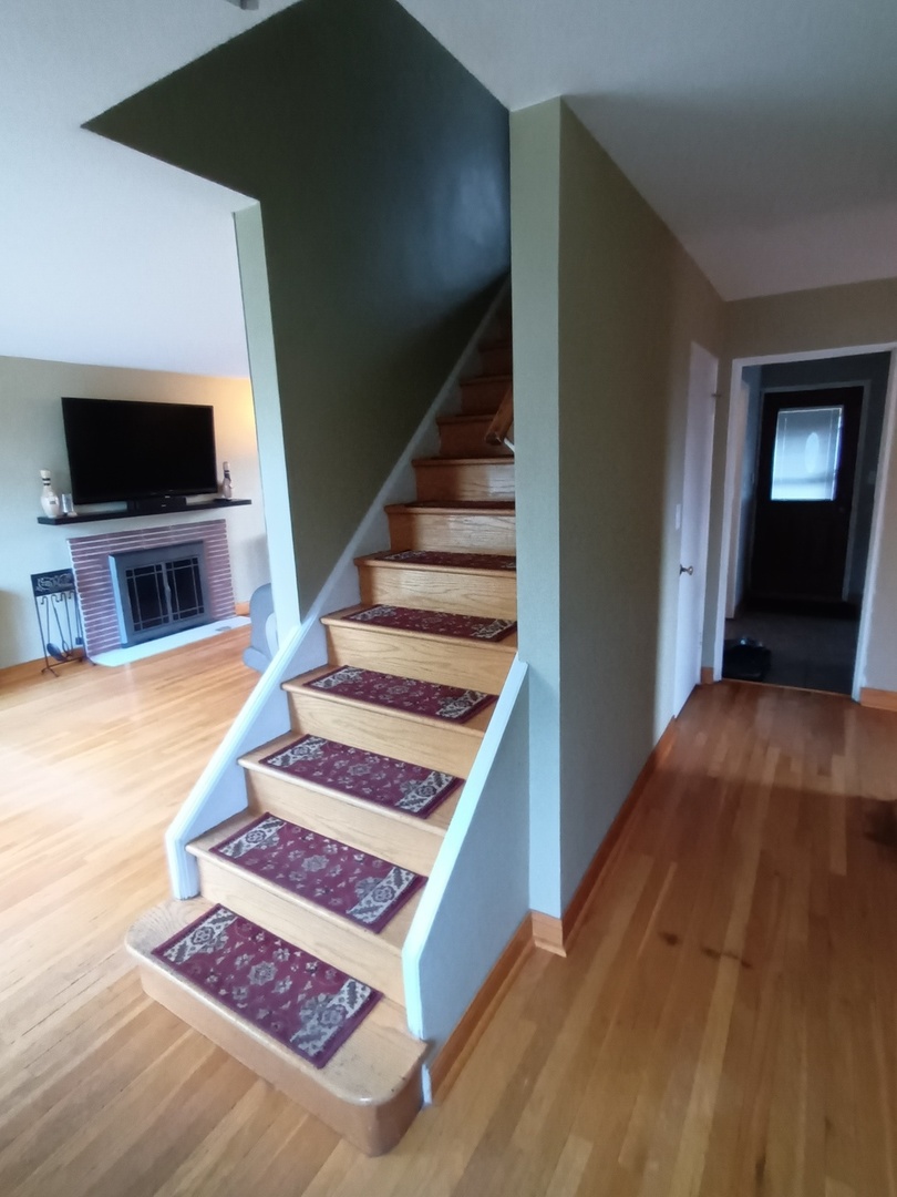 8742 East Prairie Road Skokie, IL 60076 - Photo 3 of 29 a living room with wooden floor and flat screen tv