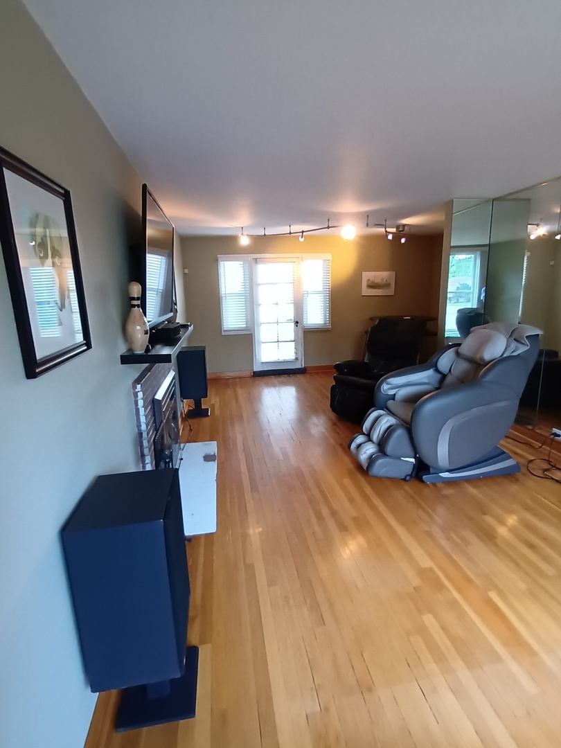 8742 East Prairie Road Skokie, IL 60076 - Photo 4 of 29 a living room with furniture and a flat screen tv