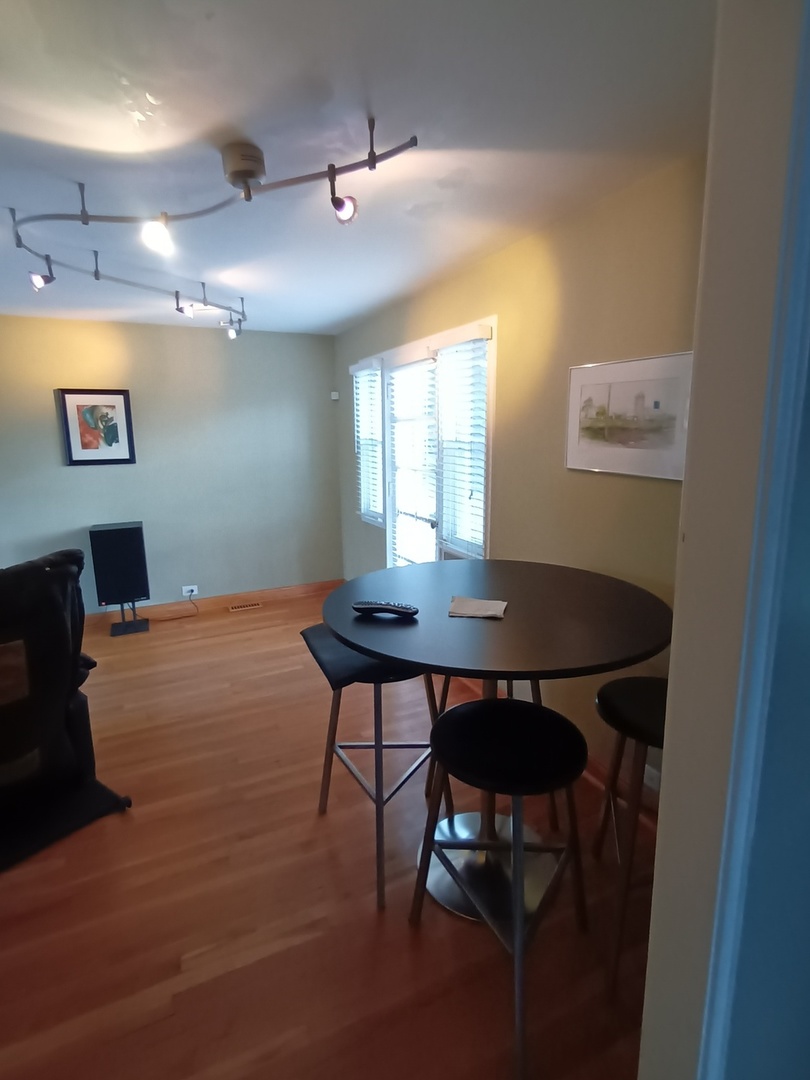 8742 East Prairie Road Skokie, IL 60076 - Photo 6 of 29 a view of a dining room with furniture and wooden floor