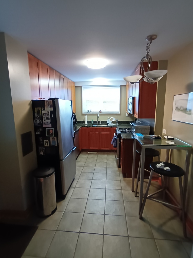 8742 East Prairie Road Skokie, IL 60076 - Photo 8 of 29 a kitchen with stainless steel appliances granite countertop a refrigerator and a stove