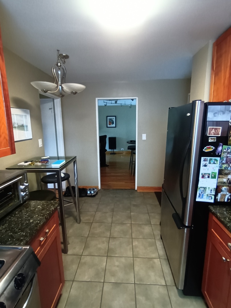 8742 East Prairie Road Skokie, IL 60076 - Photo 10 of 29 a room with furniture and a stove